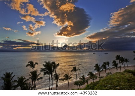 Sunset casts a golden glow over the ocean at Kaanapali Beach on Maui.