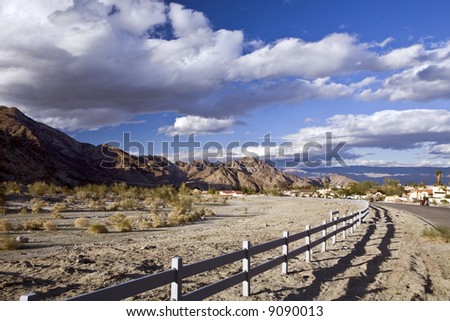 Fence borders desert parkland from the California city of La Quinta