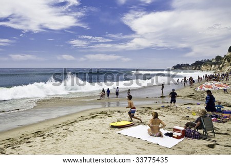 Children enjoy surf as wave roll onto Paradise Cove beach