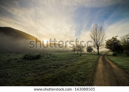 Sun rising up with early morning mist around mountains, Hastings, New Zealand