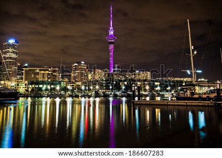 AUCKLAND, NEW ZEALAND - APRIL 10: The Sky Tower glowing royal purple to celebrate the Royal tour of New Zealand on April 10, 2014 in Auckland, New Zealand.
