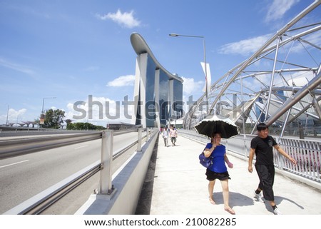 SINGAPORE - JULY 24: Unidentified people walking on street on July 24, 2014 in Singapore.