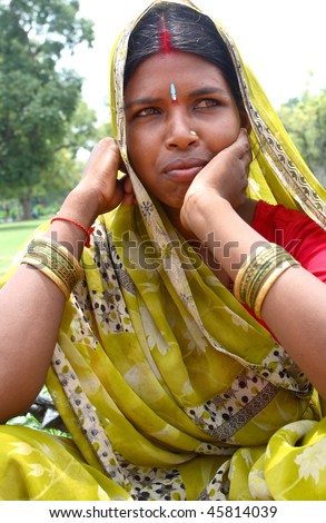 AGRA, INDIA - JUNE 19: Portrait of happy tribal woman in a city in India, Agra June 19, 2008 in Agra, India. Local women wear colorful saree (sari) as traditional clothing.