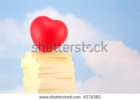 Heart on Stack of Sticky Notes, Representing Office Romance, on Sky Background