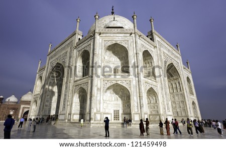 AGRA, INDIA - MARCH 06: View of the Taj Mahal, final resting place of Mumtaz Mahal wife of Moghul Emperor Shah Jehan, and unidentified tourists against a blue sky on March 06, 2010 in Agra, India.