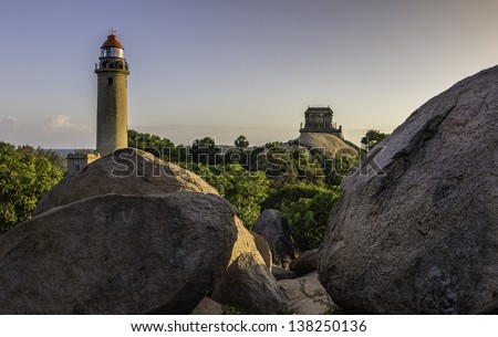 Mamallapuram, Tamil Nadu, India. View of the modern lighthouse and the ruins of the old lighthouse amongst giant granite boulders at sunset  at Mamallapuram, Tamil Nadu, south India.