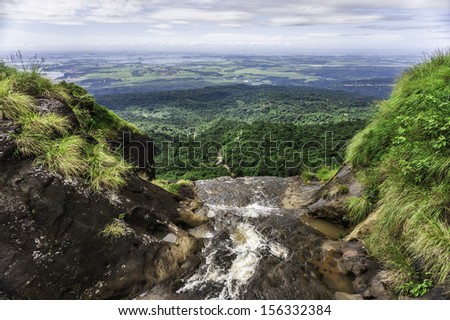 Cherrapunjee, Meghalaya, India: Waterfall from the Khasi Hills overlooking the road to and forests of Bangladesh near Cherrapunjee, the wettest place on earth, in Meghalaya, north east India.