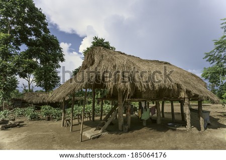 BHALUKPONG, INDIA - SEPTEMBER 13: Thatched hut on stilts typical of the Mising (aka Mishing) tribe on a sunny day on September 13, 2011 near Bhalukpong, Assam, India.