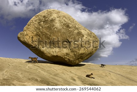 Mamallapuram, Tamil Nadu, India. A large boulder, Krishna's butter ball, named after Hindu God, Krishna, balanced precariously on granite base at Mamallapuram, Tamil Nadu, India.