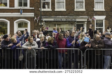 BEVERLEY, UK - MAY 02, 2015: Spectators enjoy the Tour de Yorkshire cycle race during the wait for the main peloton of cyclists along the North Bar Within on May 02, 2015 in Beverley, Yorkshire, UK.
