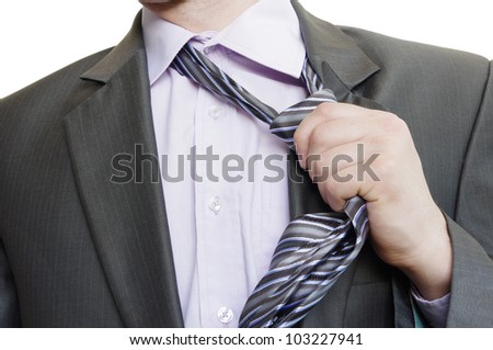 suited man tearing off his tie on white background