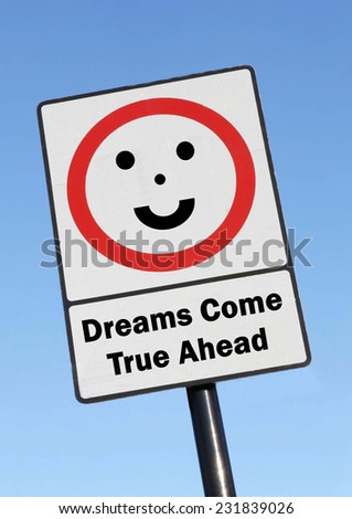 Dreams Come True Ahead written on a road sign with a smiling face against a clear blue sky background