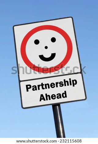 Partnership Ahead written on a road sign with a smiling face against a clear blue sky background