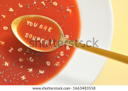 Similar – Image, Stock Photo spoon with letters soup noodles in a white soup plate next to semolina gnocchi and carrot german text hair