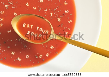 Similar – Image, Stock Photo spoon with letters soup noodles in a white soup plate next to semolina gnocchi and carrot german text hair