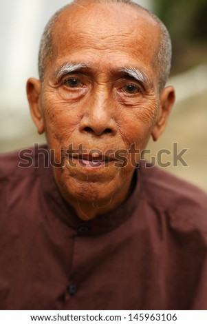 YANGON - MYANMAR - DECEMBER 1: An unidentified old Burmese man on December 1, 2013 in Yangon, Myanmar. In 2012 an ongoing conflict started between Buddhists and Muslims in Myanmar.
