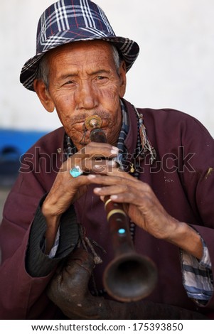 LEH - INDIA - SEPTEMBER 25, 2013: Unidentified musician at a traditional Buddhist mask dance of the annual Ladakh Festival 2013 on September 25, 2013 in Leh, India.