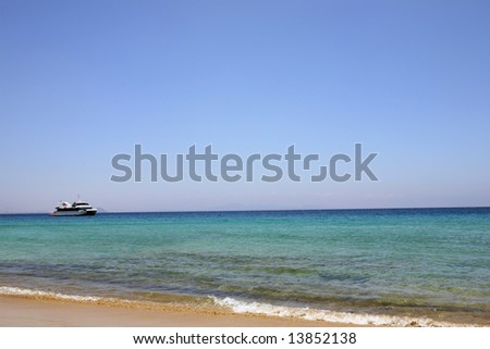 beach with nice blue water and pleasure craft have much space for text advertisement