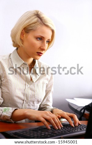 Young businesswoman working on the computer in the office