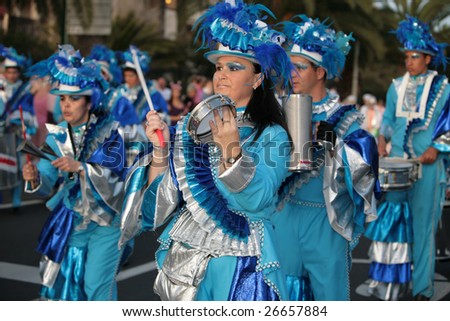 LANZAROTE, SPAIN - March 14: Women and man in costumes march at the Grand Carnival Parade in Costa Teguise, on March 14, 2009. Lanzarote, Canaries islands, Spain.