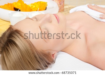 woman in spa on white towel with blond hair