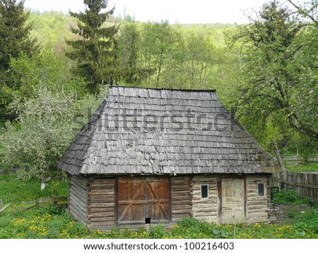 Traditional barn located in a rural village in northern Romania in Eastern Europe. It is built of timbers with corner notching and wood shingle roof.