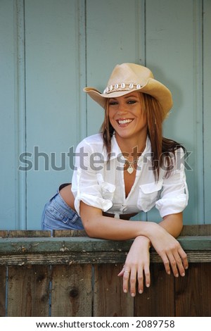 Pretty blond cowgirl with cowboy hat.