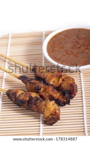 Asian food - Chicken Satay with peanut sauce in bamboo mat
