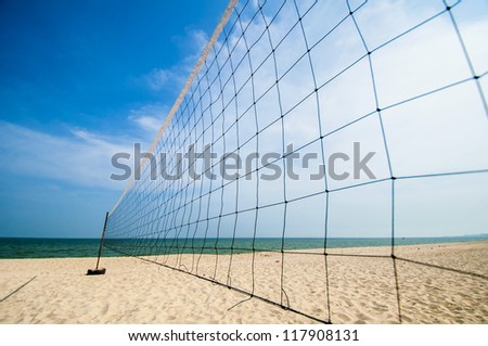 Torn beach volleyball net at tropical beach