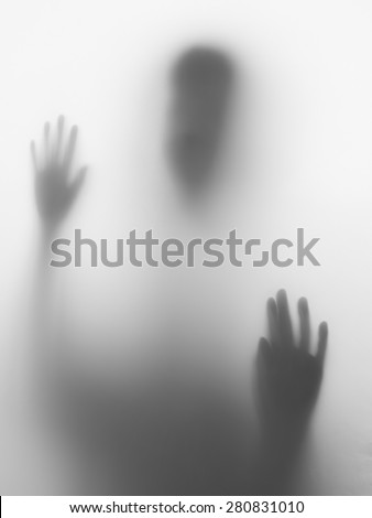 Children head and hands silhouette on glass