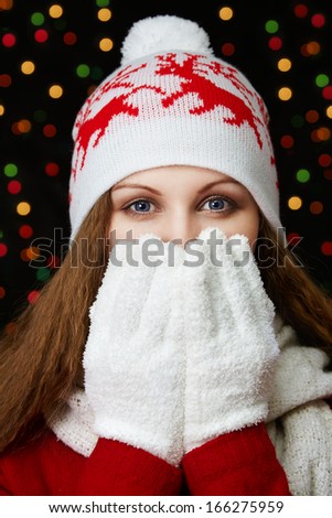attractive woman in winter clothes on a background of blurred lights