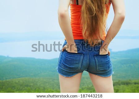 woman standing outdoors on a background the scenic view. back view