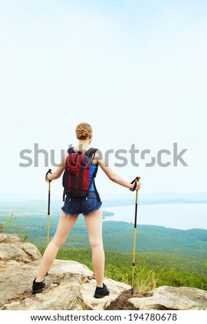 young woman with backpack hiking in the mountains. people outdoors