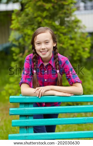 Beautiful smiling teenage girl in a summer park. youth lifestyle