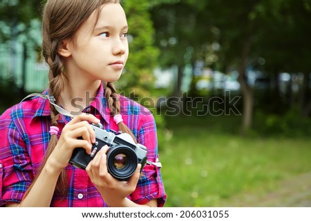 teenage girl with a camera. old photo camera. youth lifestyle