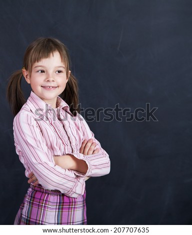 Portrait of a schoolchild on a background of the board. School and education