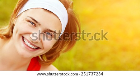 Portrait of sporty smiling woman on a grass background. outdoor sports. banner