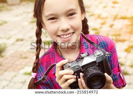 teenage girl with a retro camera. old photo camera. youth lifestyle