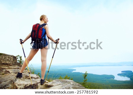 young woman with backpack hiking in the mountains. people outdoors. healthy lifestyle