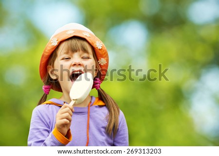 Portrait of a cute girl with ice cream on a walk in the park. child outdoors