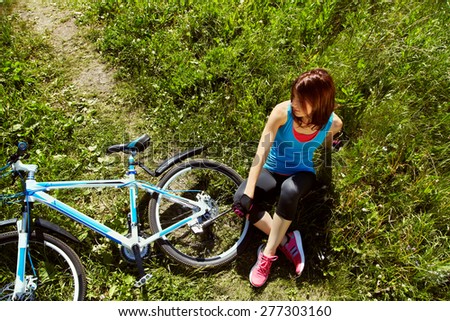 young woman with a bike in a summer park. Active people outdoors. sport lifestyle
