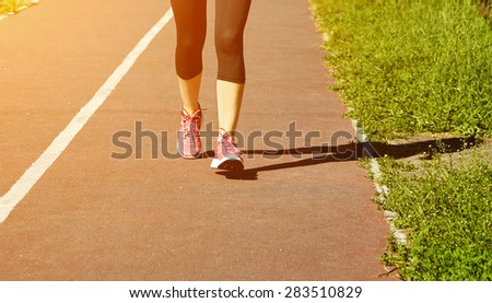 selective focus.. runner feet closeup. athlete running on jogging track at the stadium. running shoes. jogging outdoors