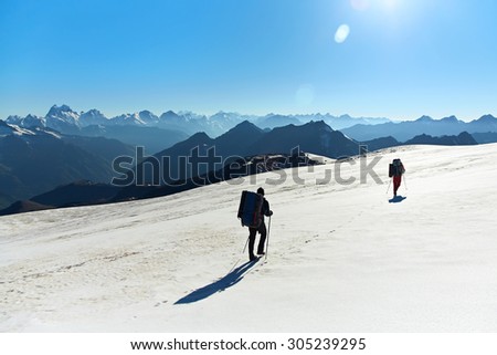 Group of hikers in the mountain. Climb to the top. mountaineering