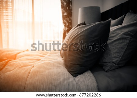 Similar – Foto Bild Das Bett ist mit sauberen weißen Kissen und Bettwäsche im Zimmer ausgestattet.