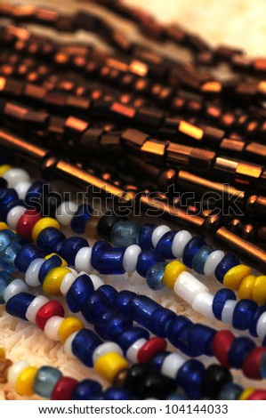 Multicolored strands of seed beads on a necklace