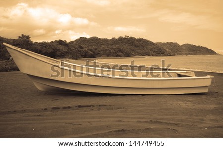 boat in ocean with hills and nature in sepia