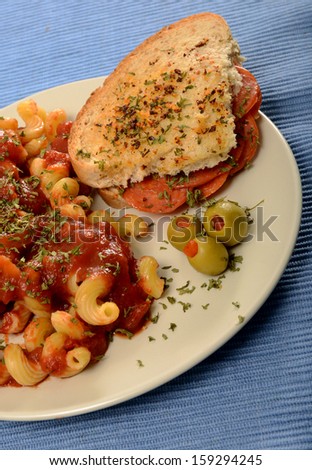 italian cuisine with salami sandwich and pasta