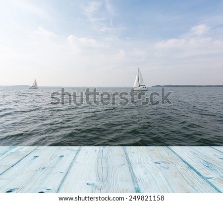 yachts on lake. landscape with wooden planks floor on foreground