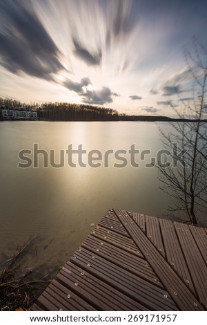 Beautiful long exposure landscape of lake in Mazury lake district (Krzywe lake near Olsztyn).