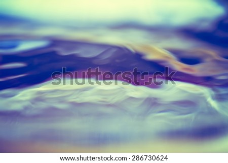 Abstract background of moving water surface in big close up. Photo with vintage colors.